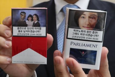 Savvy Entrepreneurs Cover Graphic Smoking Warnings with Ad Stickers